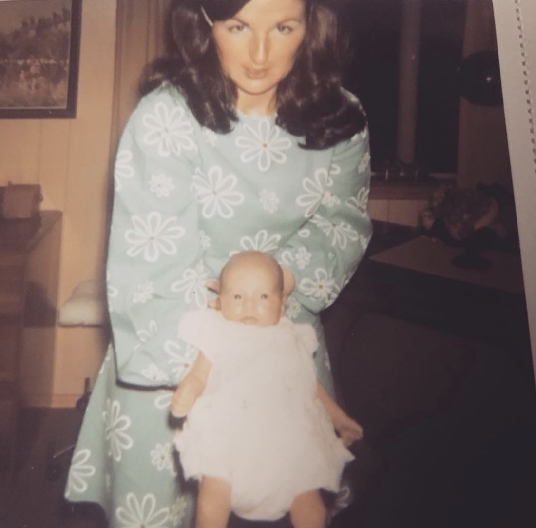 Angela as a baby, held by her mother